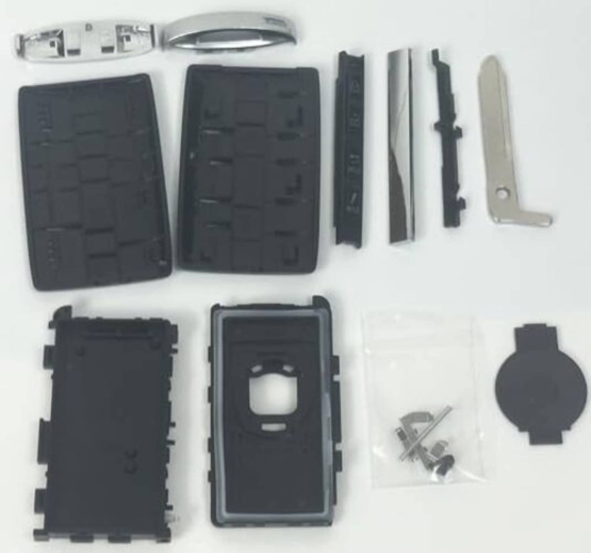 Disassembled black key fob case shell kit with buttons, insert, blade, and screws