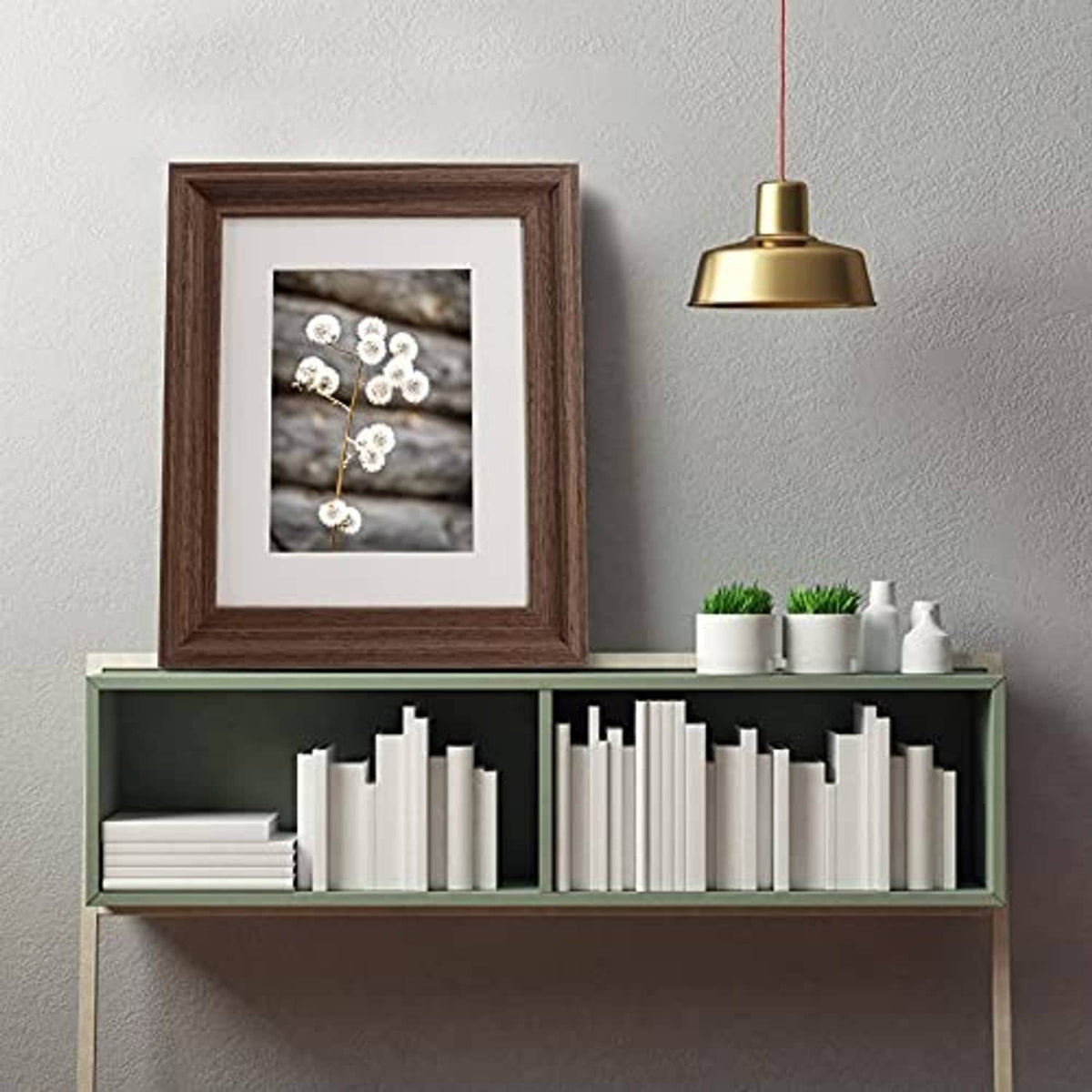 Dark brown wood picture frame with white mat, displayed on a wall shelf.