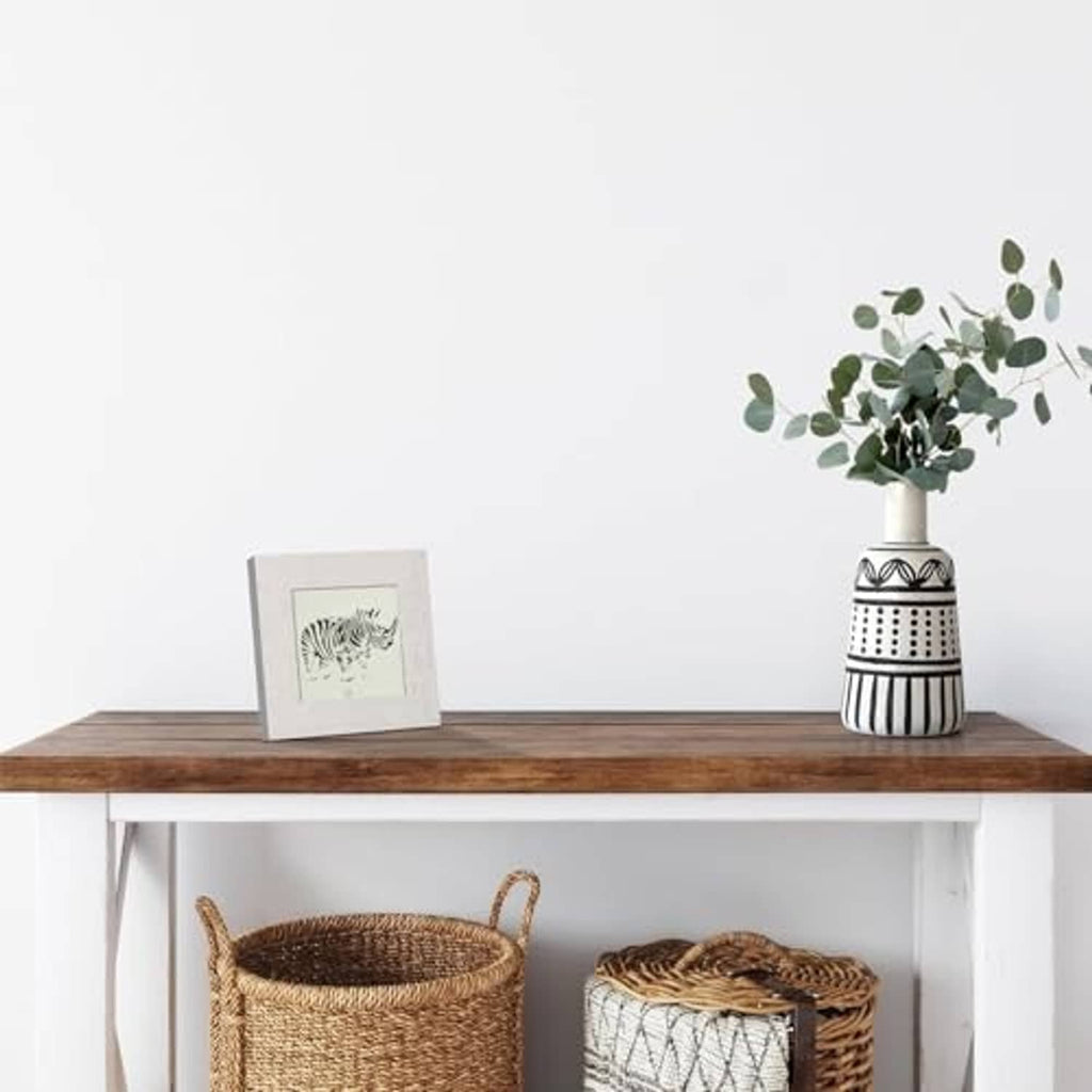 Single rustic white 4x4 picture frame with clear glass on a wooden shelf
