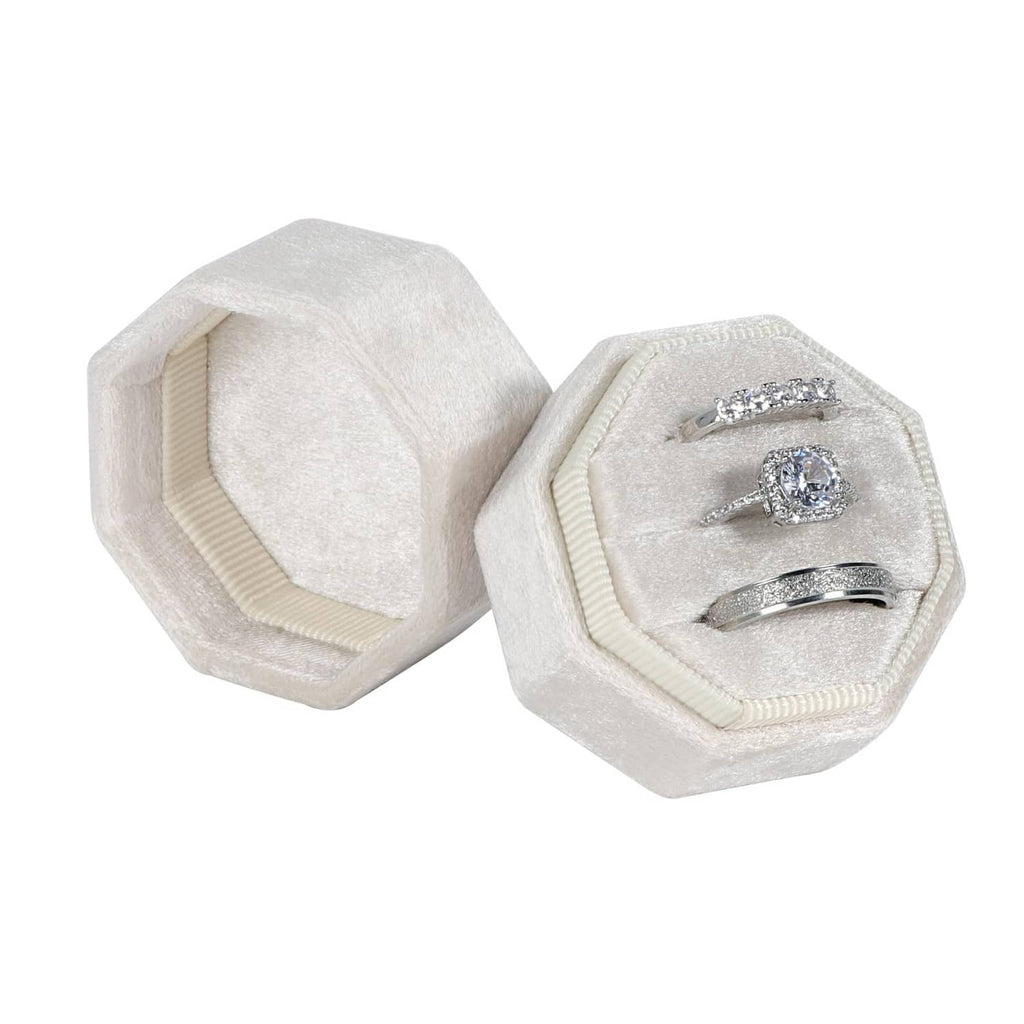 Beige octagon velvet ring box, open with ring and band in slots