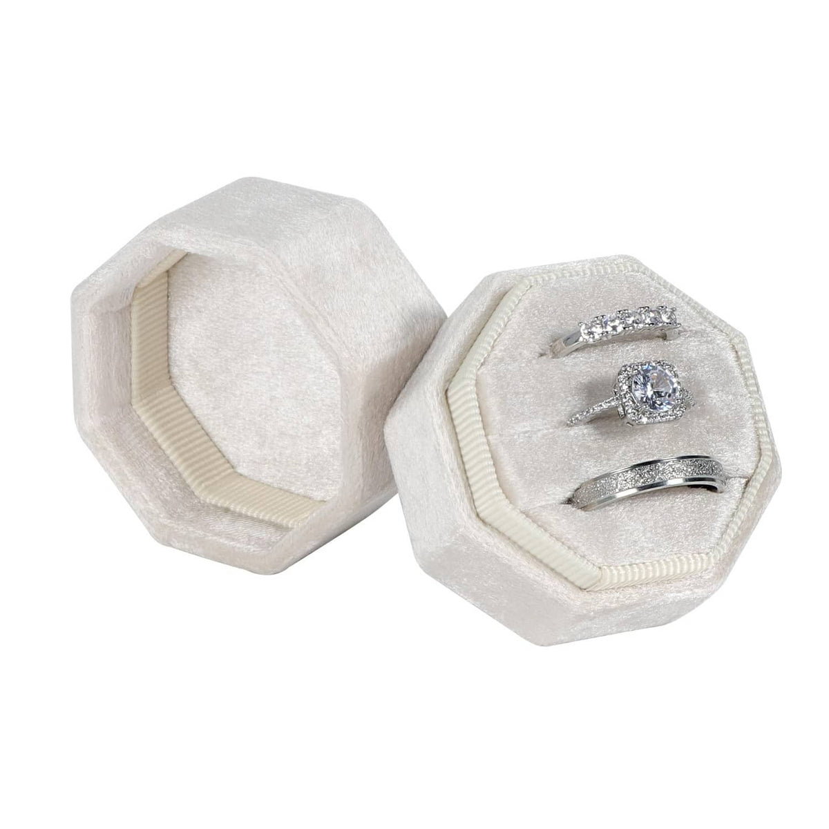 Beige octagon velvet ring box, open with ring and band in slots