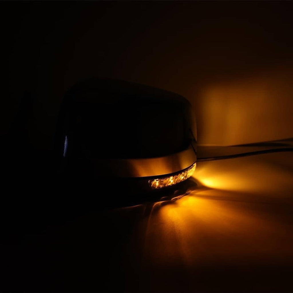 Side mirror blind spot indicator with black housing and amber light strip