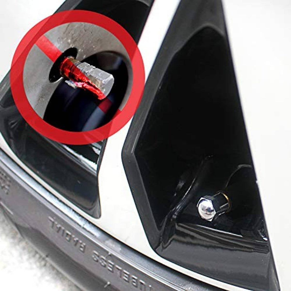 Tire valve stem cap installed on wheel valve, chrome cap with red rubber seal