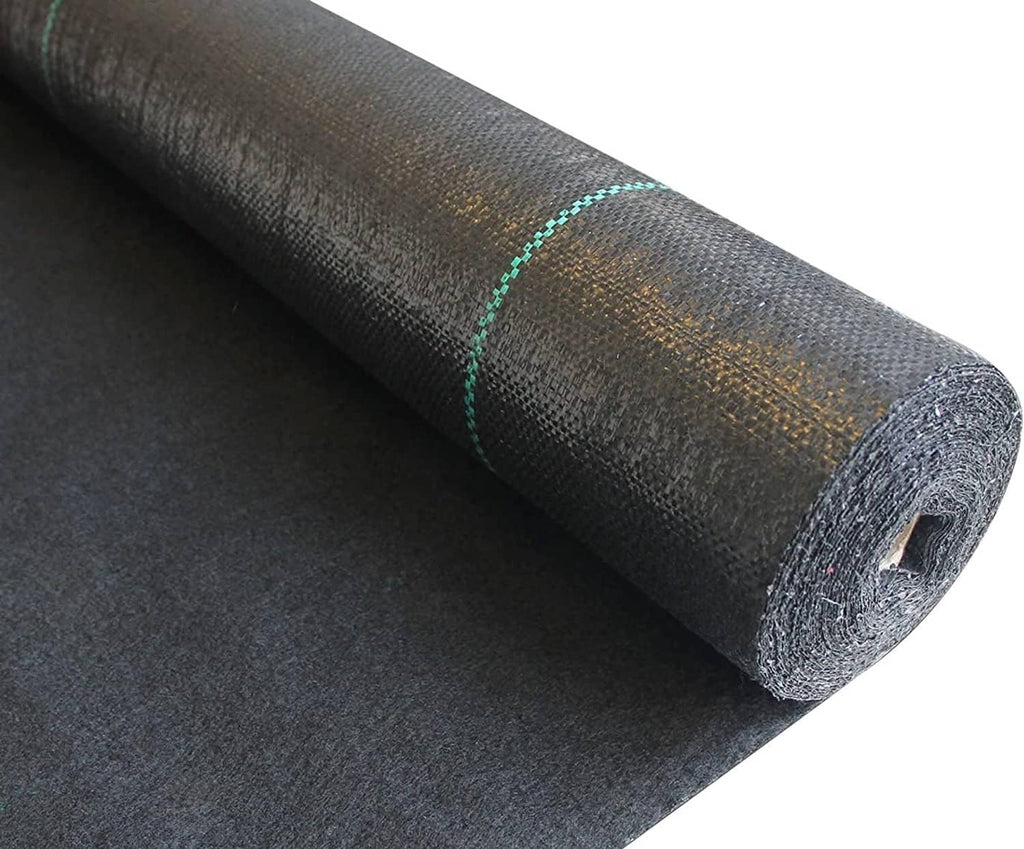 Black weed barrier fabric roll laid open, showing cut edge and woven texture.