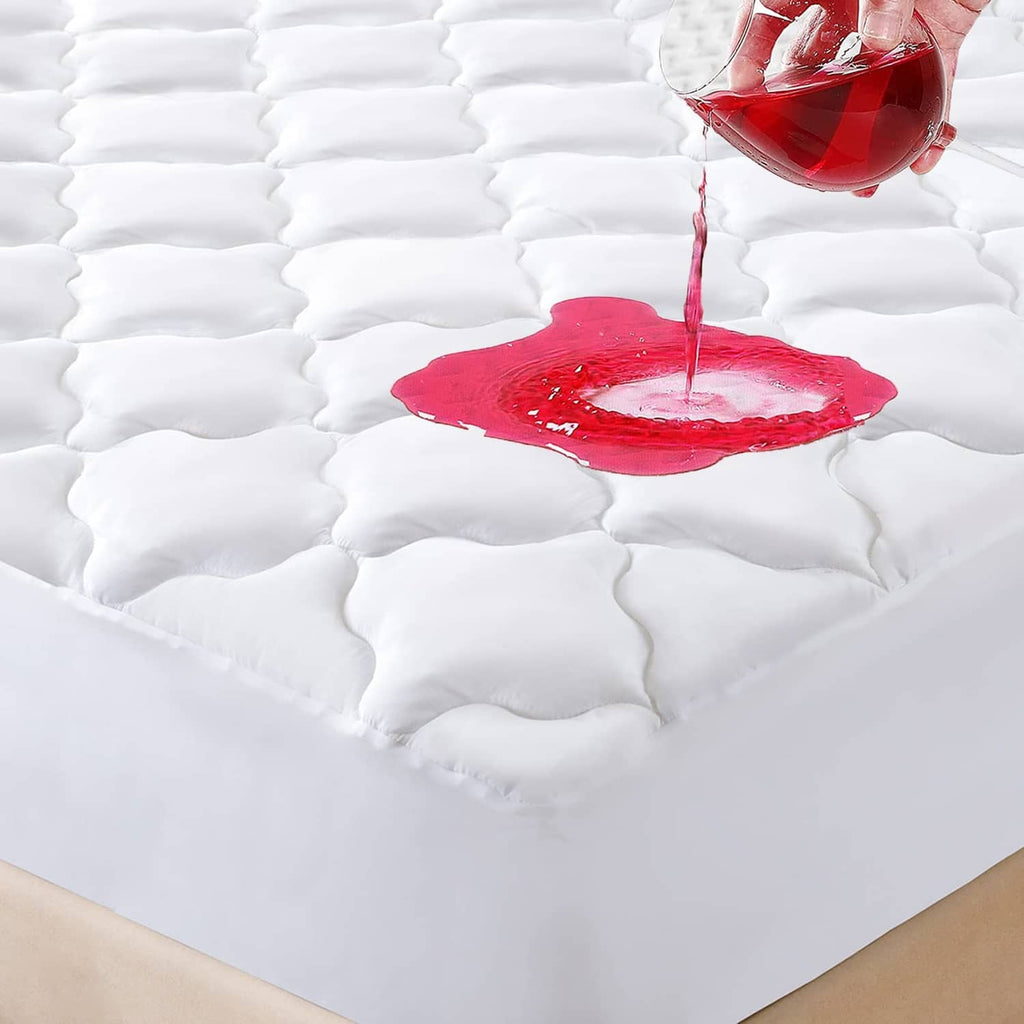 White quilted waterproof queen mattress protector with water droplet on surface