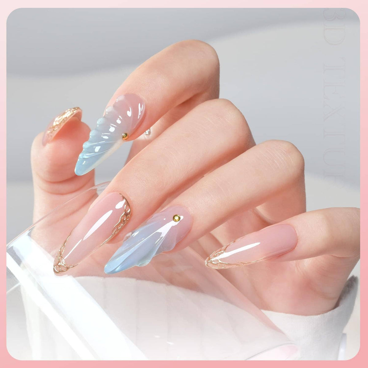 Nail gel manicure set with pastel blue and nude nails on fingers, plus gold accents