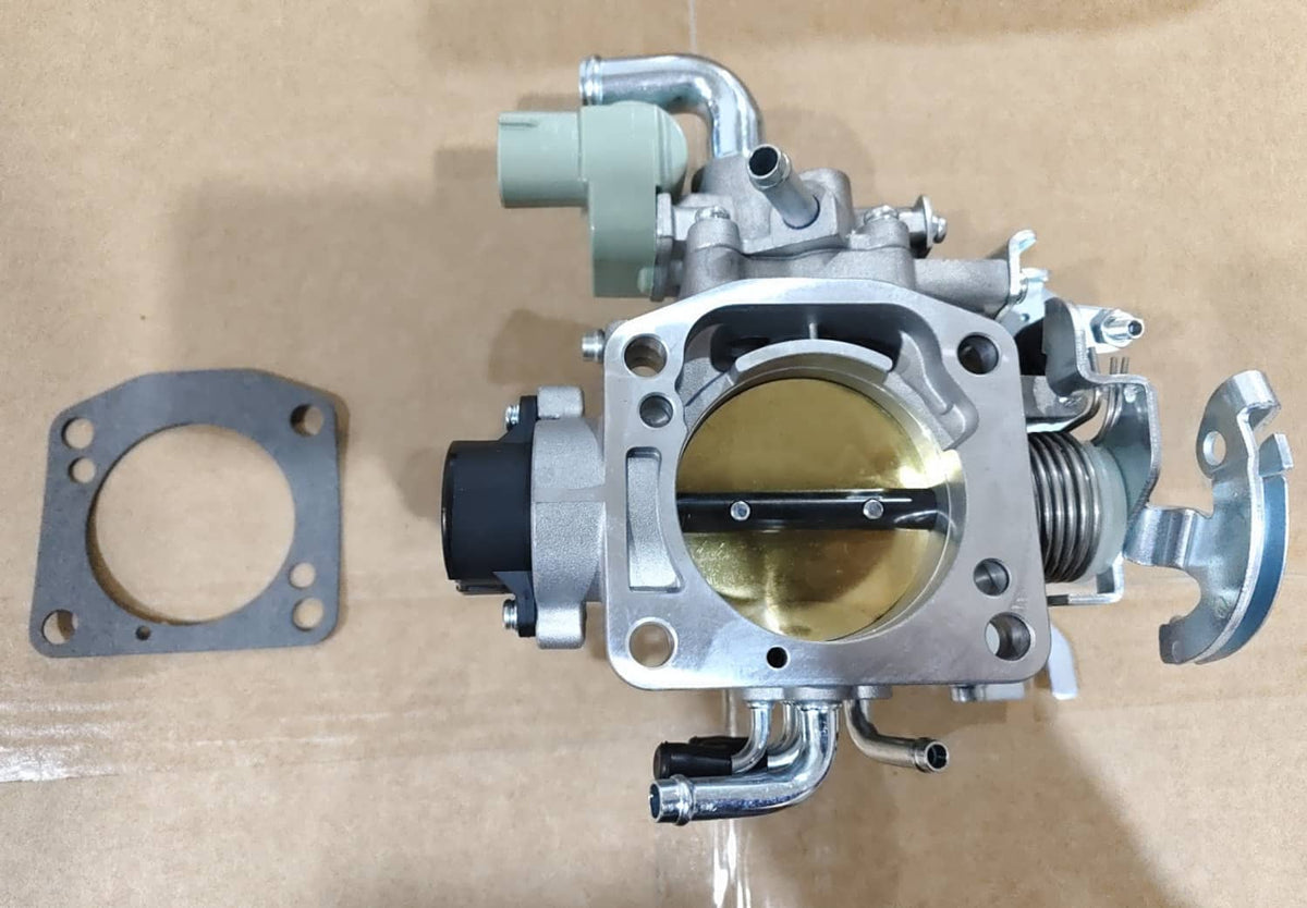 Throttle body assembly with gold bore and attached gasket, viewed from above