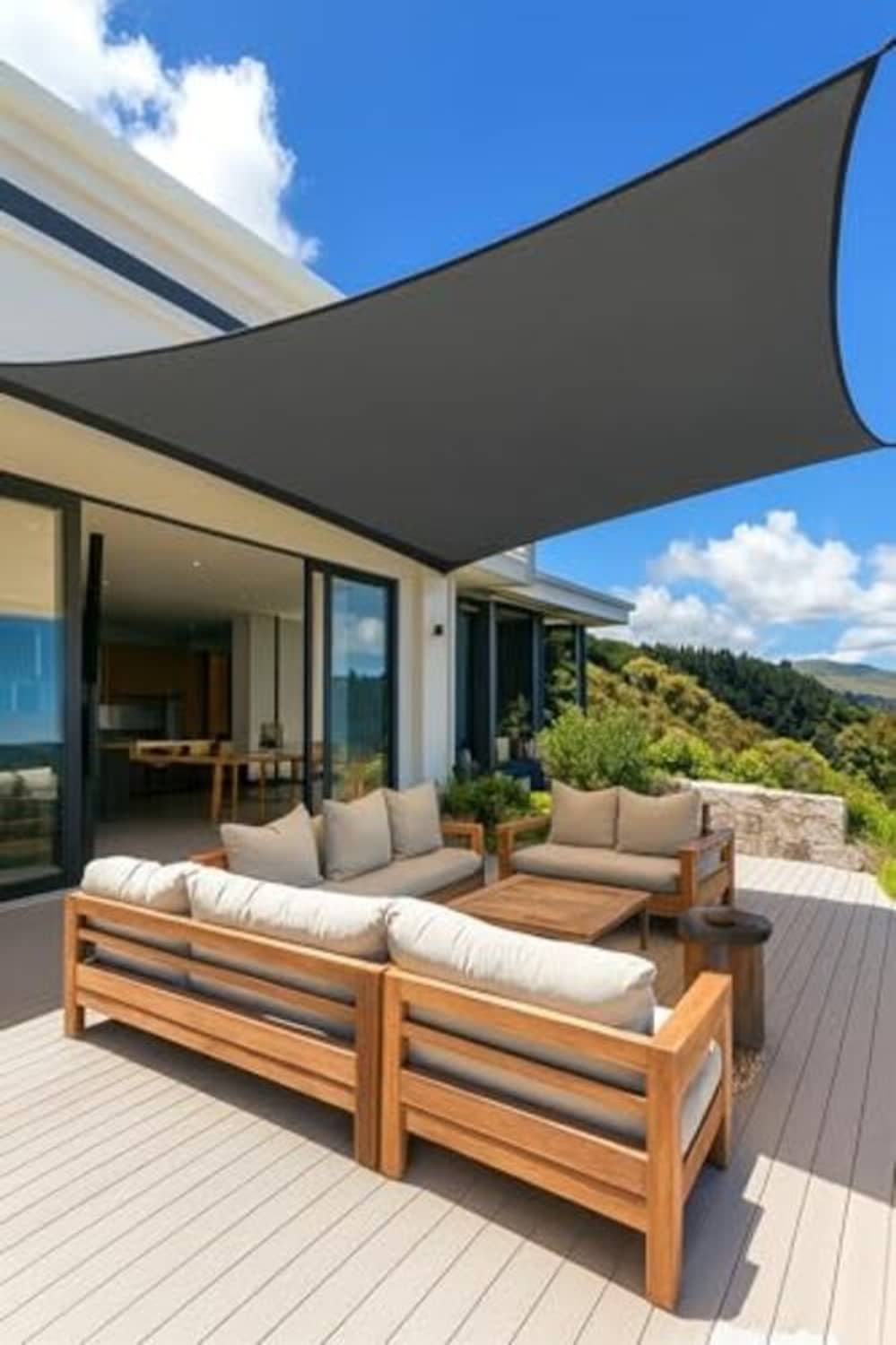 Gray rectangle sun shade sail over outdoor sofa set on wooden deck