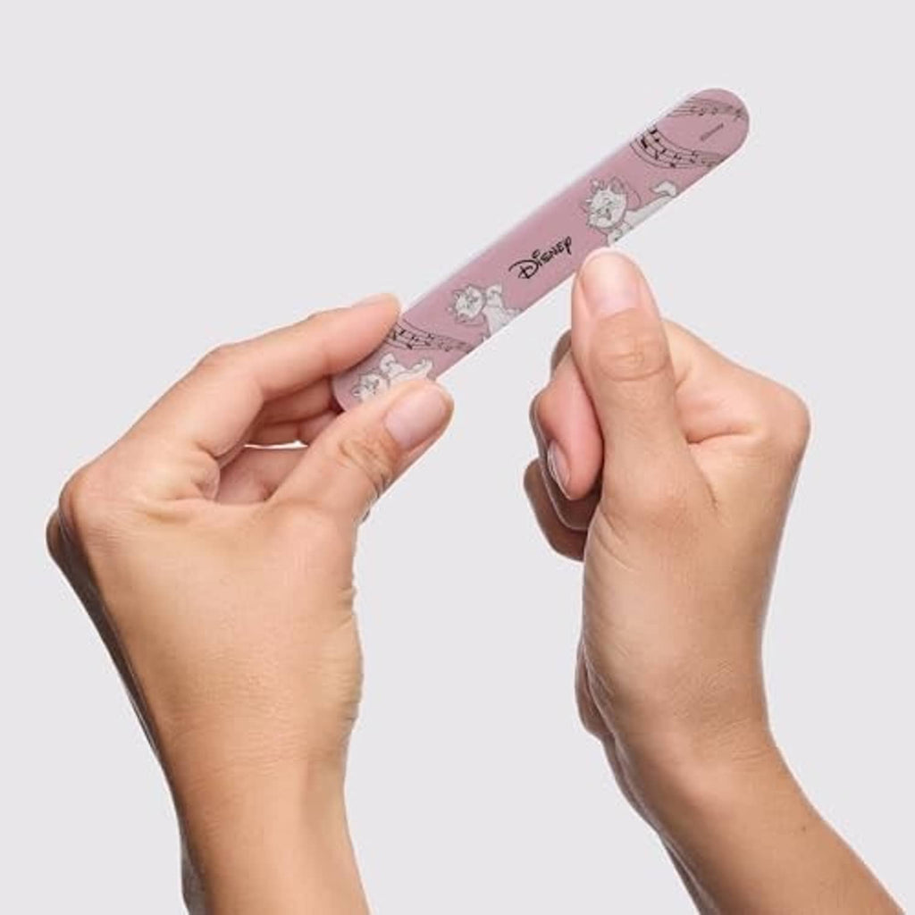 Hands using a pink Disney-patterned nail clipper on fingernail