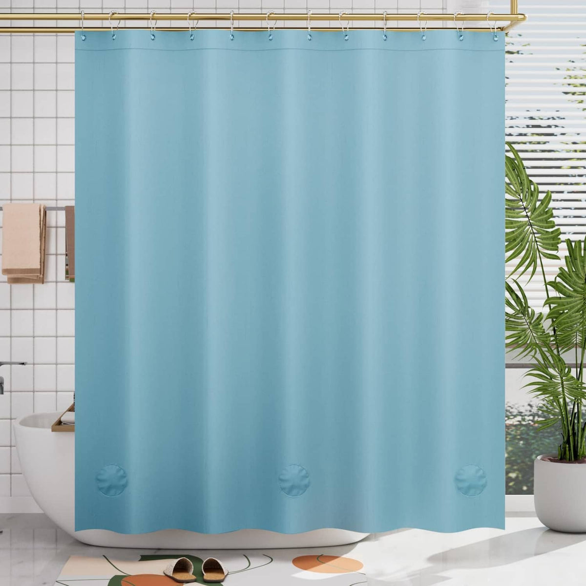 Teal plastic shower curtain with shell motifs at the bottom hem and grommet top