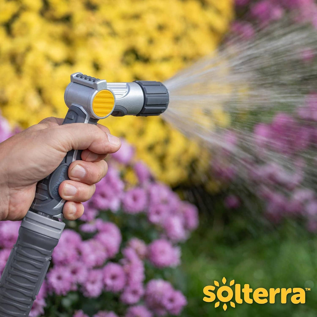 Adjustable hose nozzle spraying water from yellow dial, gray body and thumb control
