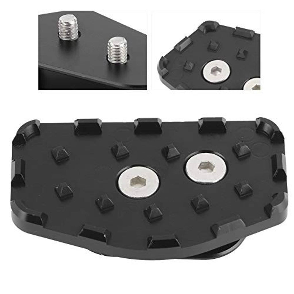 Black brake pedal extension pad with textured surface, traction studs, and metal inserts