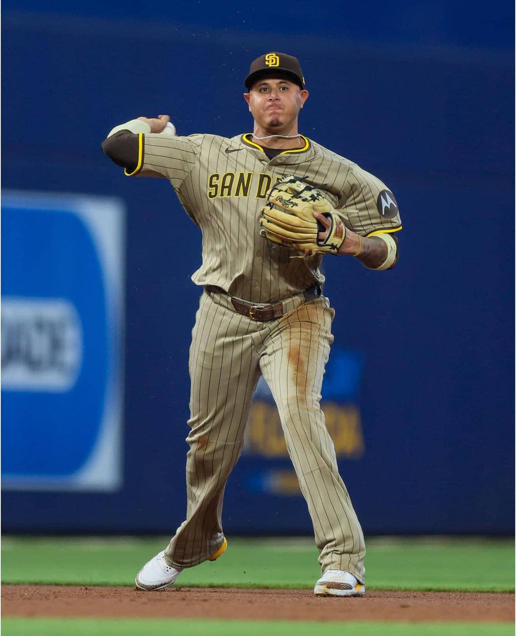 Baseball glove on player's hand during game, tan and navy