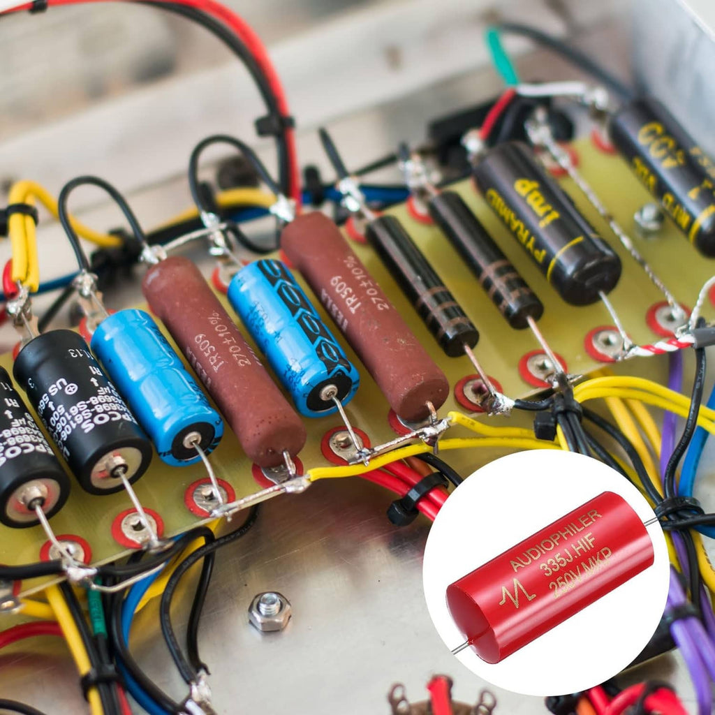 Red axial capacitors installed on an audio circuit board, with metal lead wires