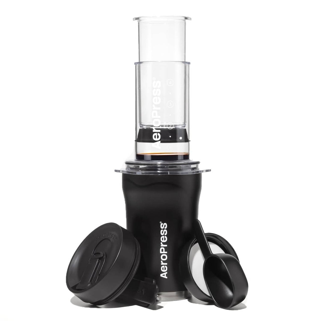 Black AeroPress Go Plus portable coffee maker kit with clear brewing chamber and lid.