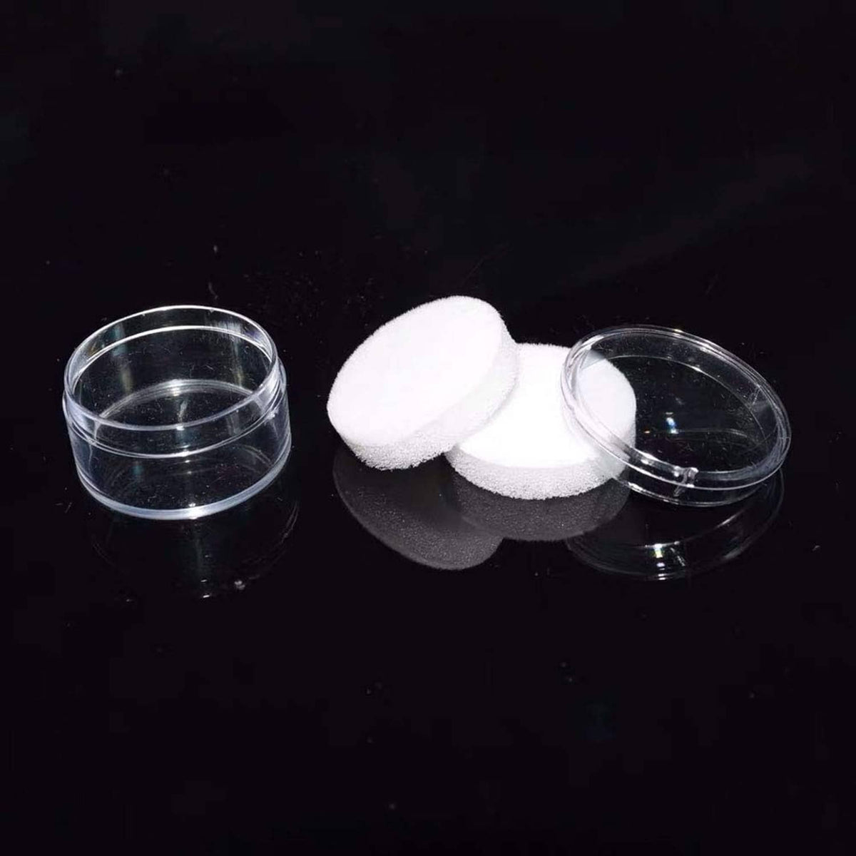 Clear round gemstone display boxes with white foam pads and open lids
