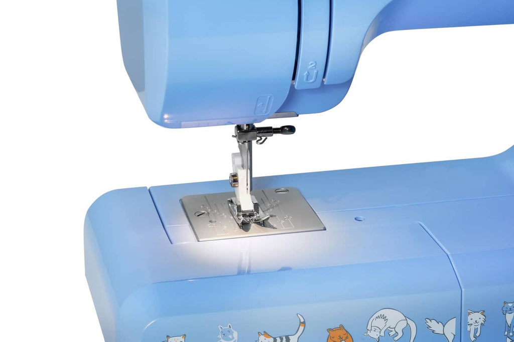 Blue Janome sewing machine close-up of needle and presser foot on metal plate