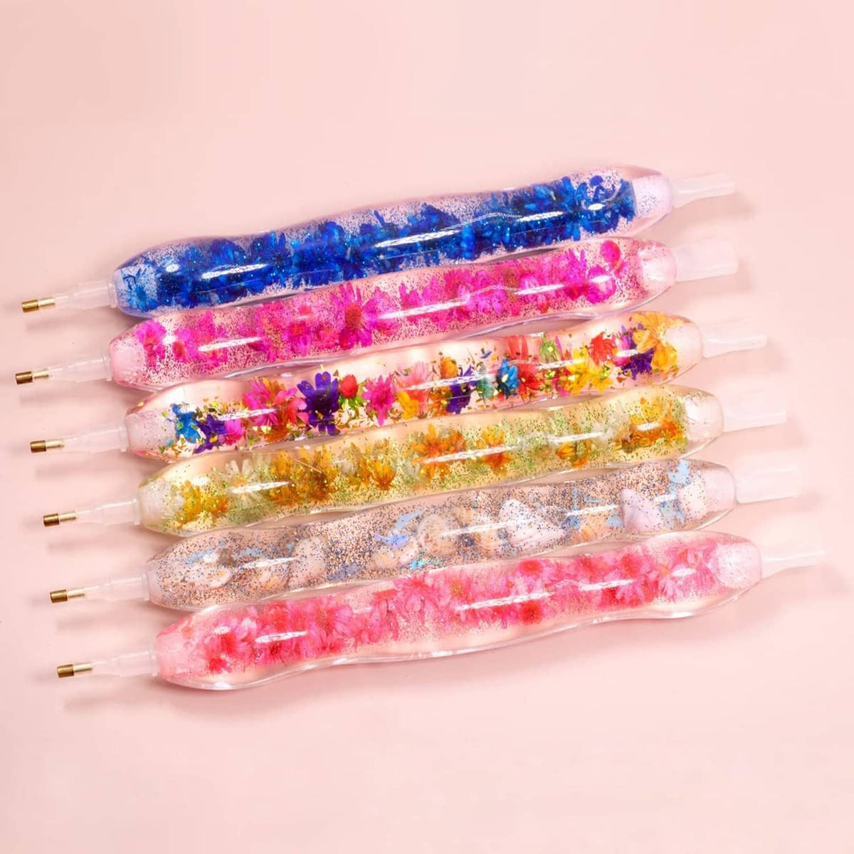 Row of five multicolor glitter diamond drill pens with clear nozzles
