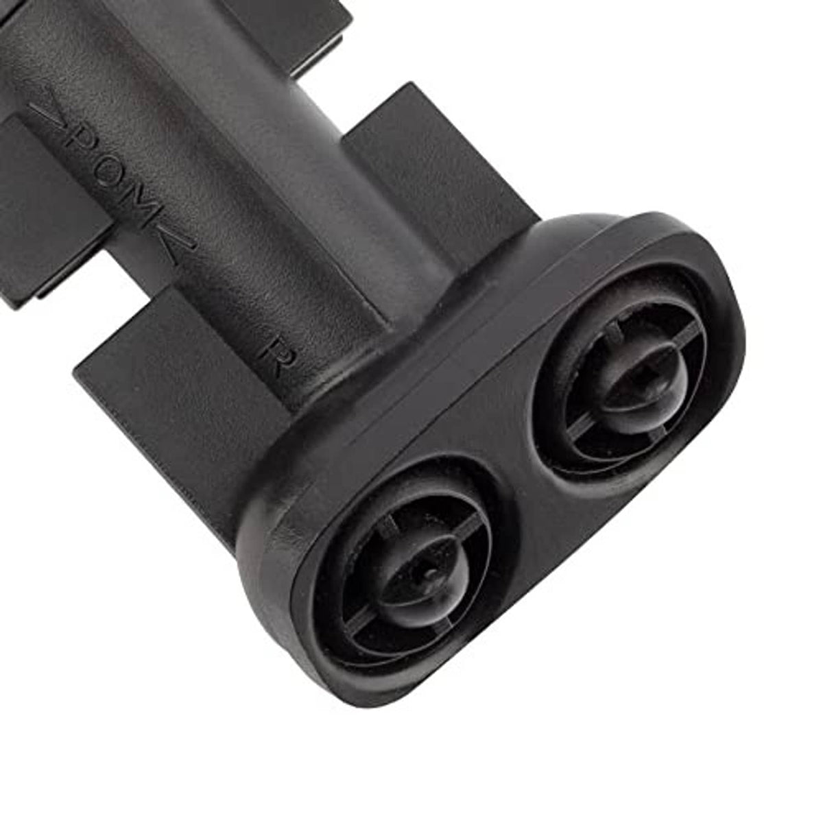 Black plastic headlight washer nozzle jet sprayer close-up of dual circular outlet nozzles