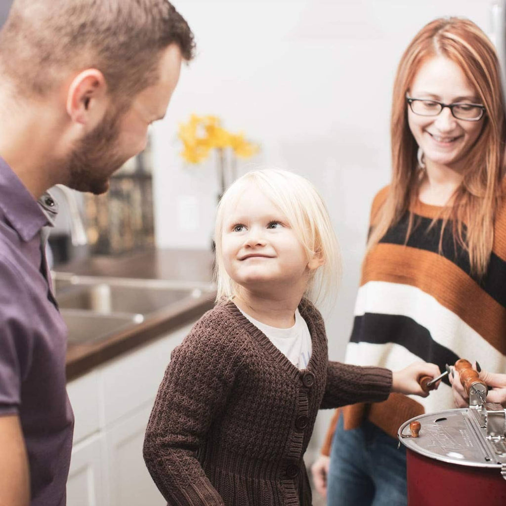 Family preparing popcorn with a bag of kernels on the countertop