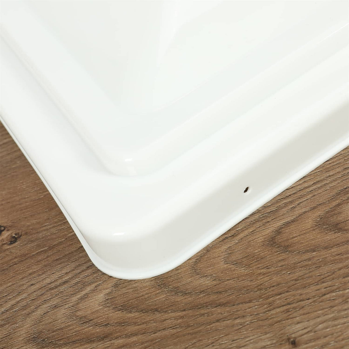 Close-up of a white RV roof vent cover corner edge