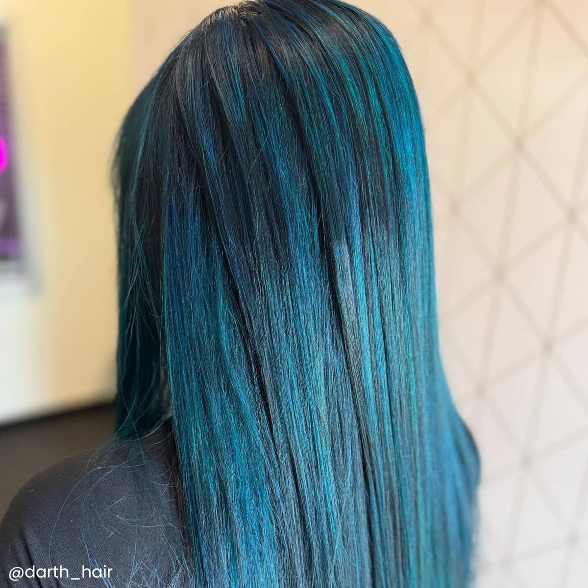 Dyed hair strands, vivid teal-blue long hair close-up