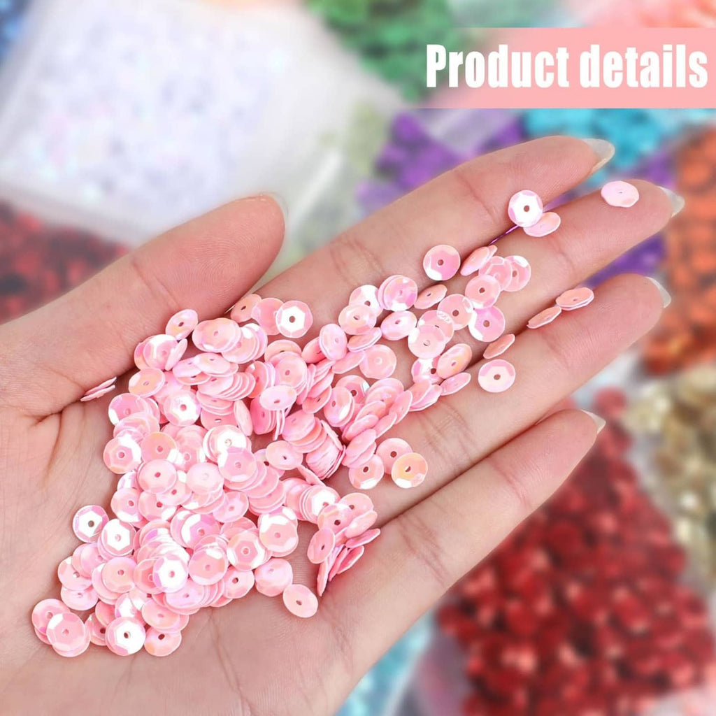 Pink iridescent round cup sequins on hand, glossy reflective craft sparkle pieces