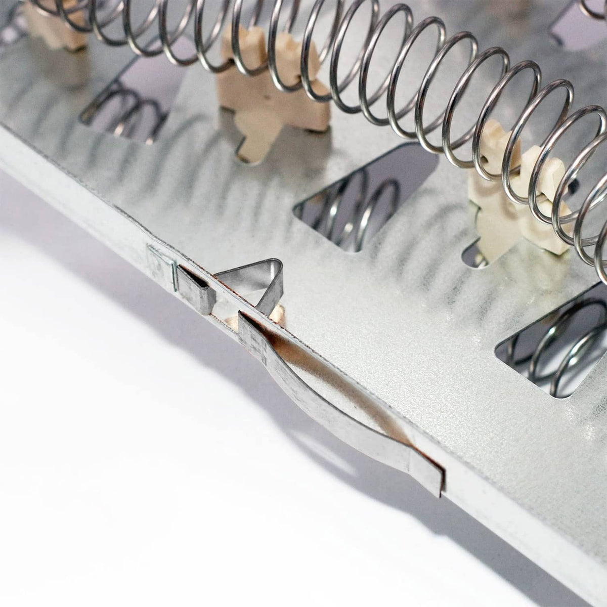 Dryer heating element metal frame with mounting slot and coil spring ends