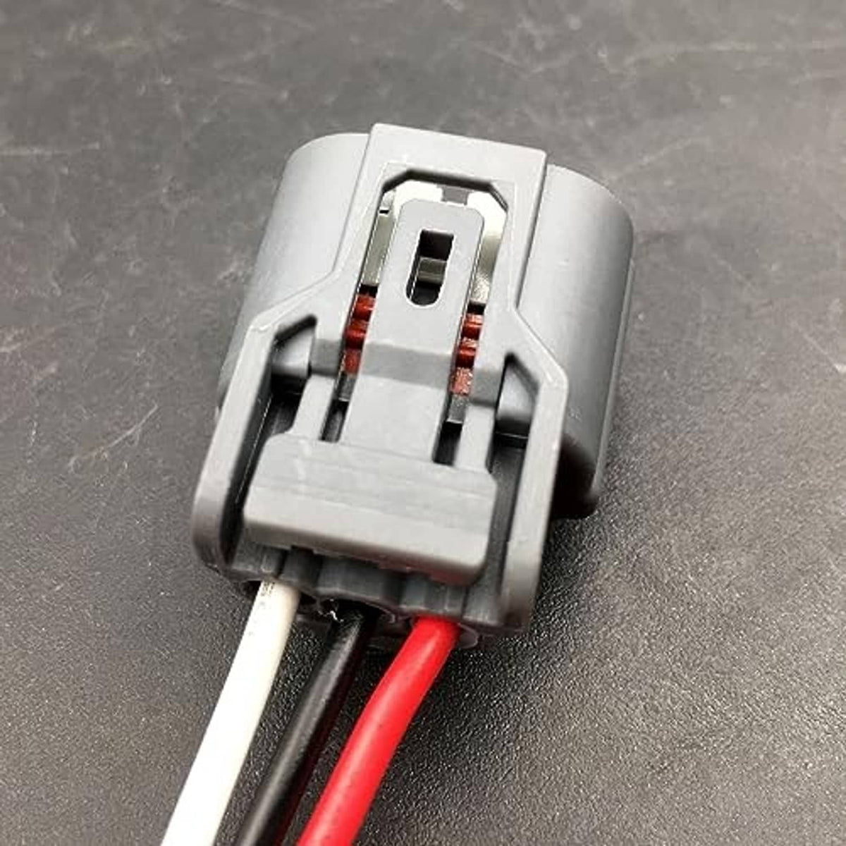 Daytime running light connector pigtail with white housing and red wire leads