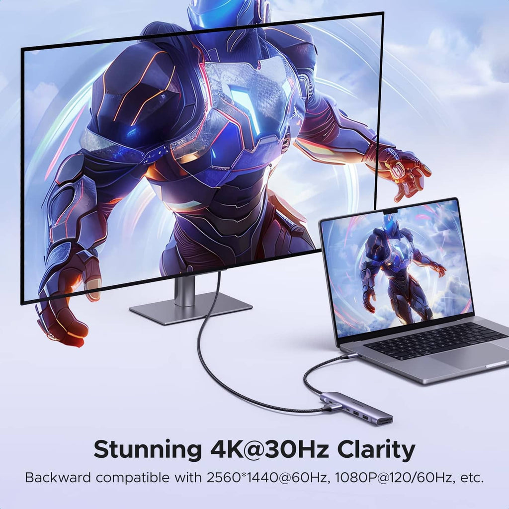 USB-C docking hub connected to laptop and external monitors, space gray body