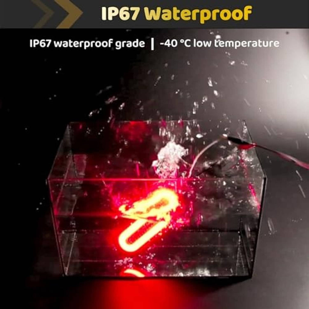 Red oval LED trailer light glowing through water splash, IP67 waterproof