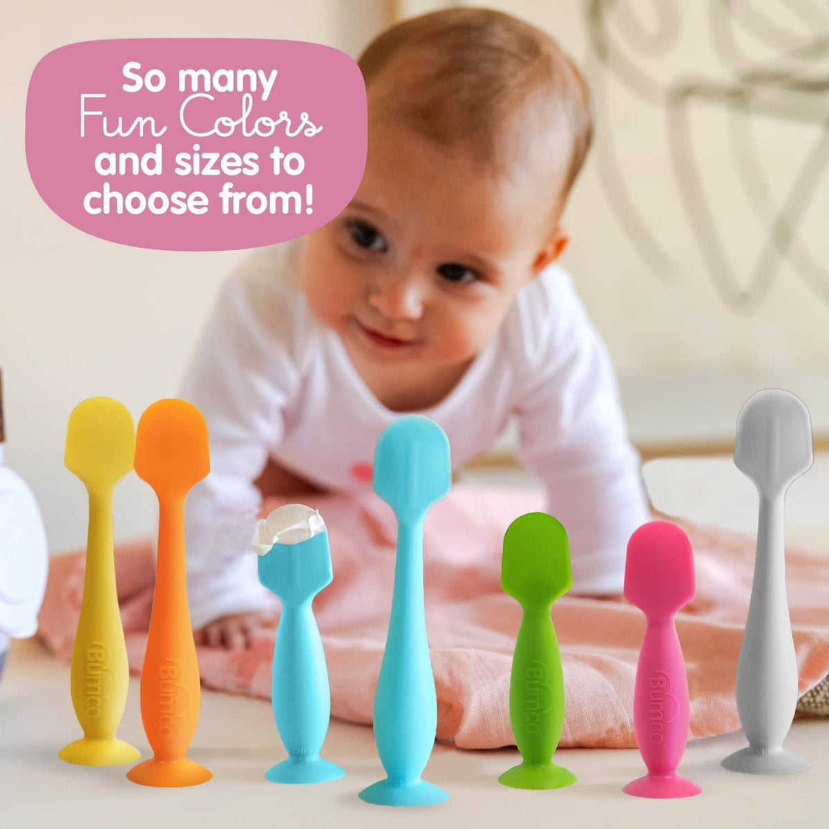 Assorted silicone baby bum brushes with suction bases in blue and other colors.