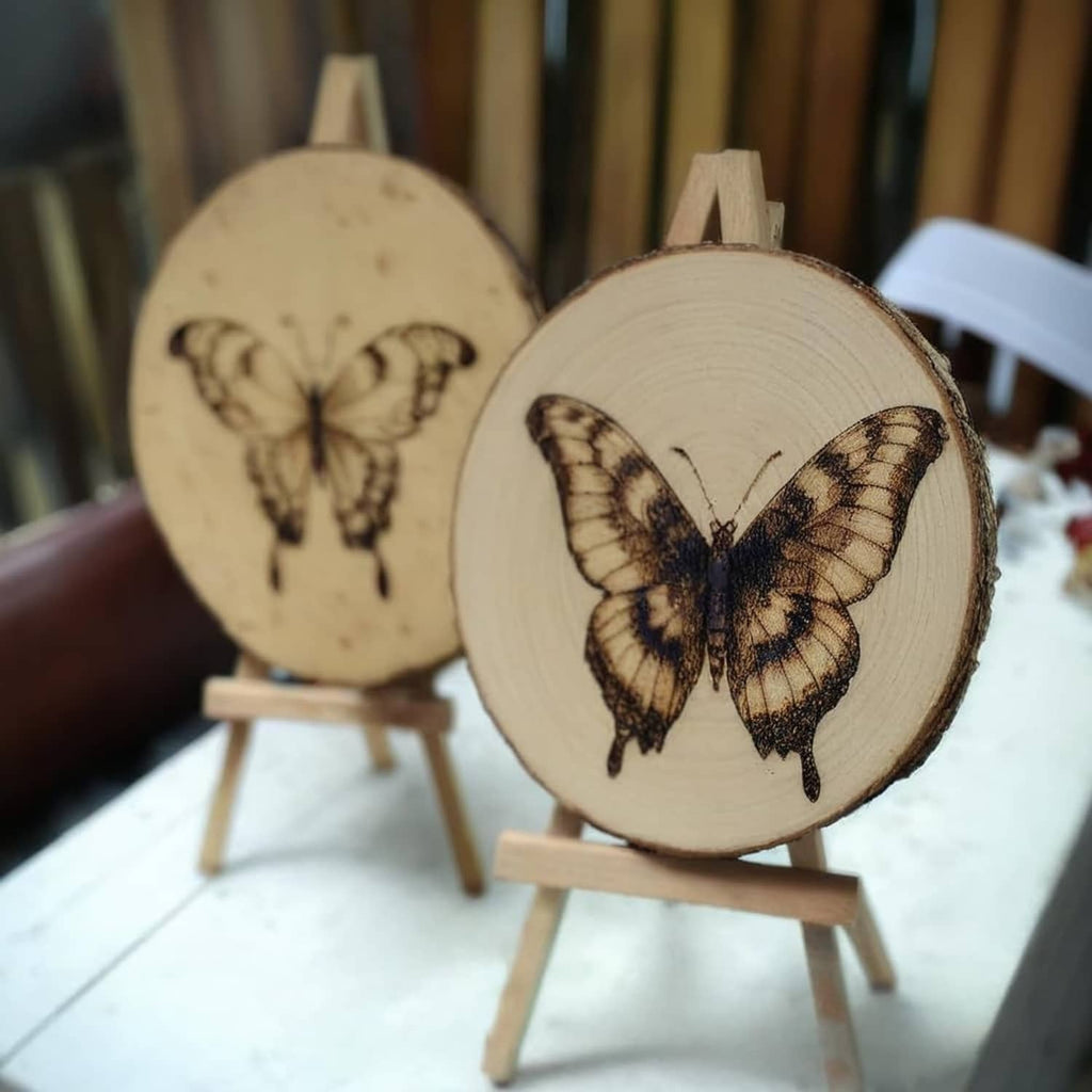 Butterfly-themed round wood slices on small easels