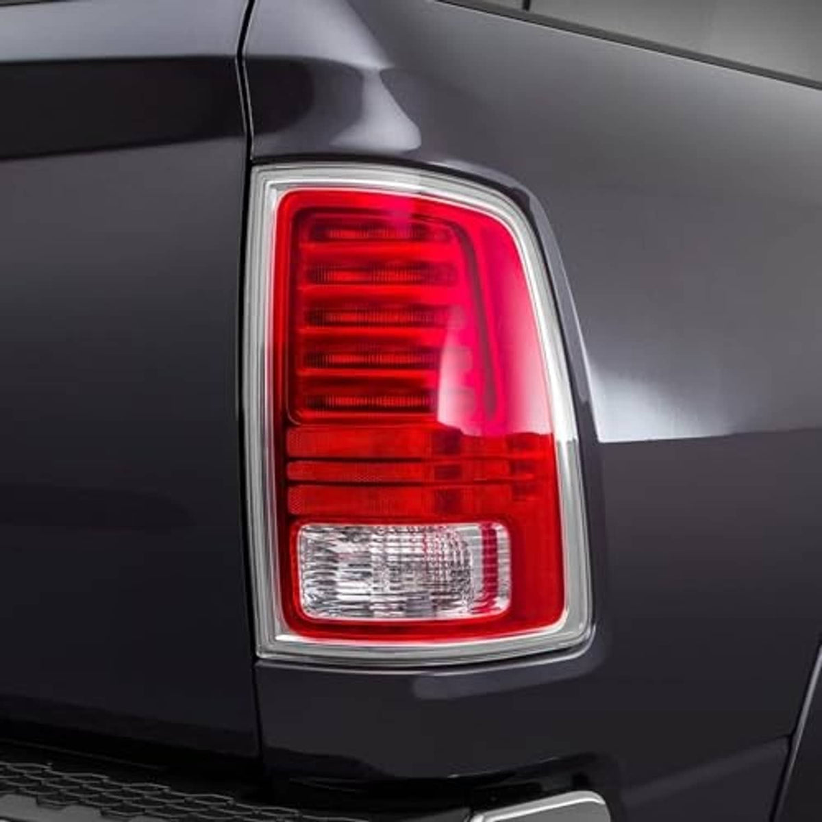 Passenger-side tail light with red lamp and clear reflector in chrome bezel.