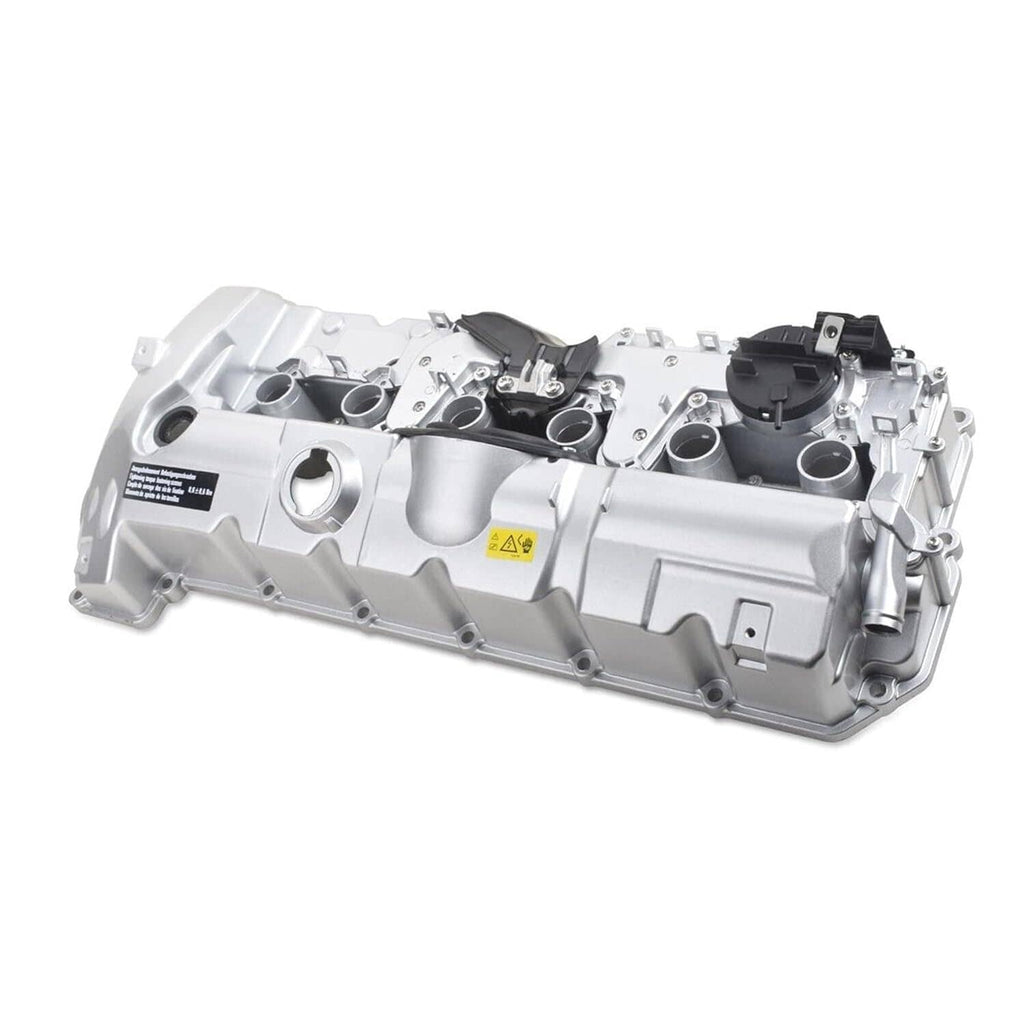 Silver aluminum valve cover with mounting points and black components, angled view