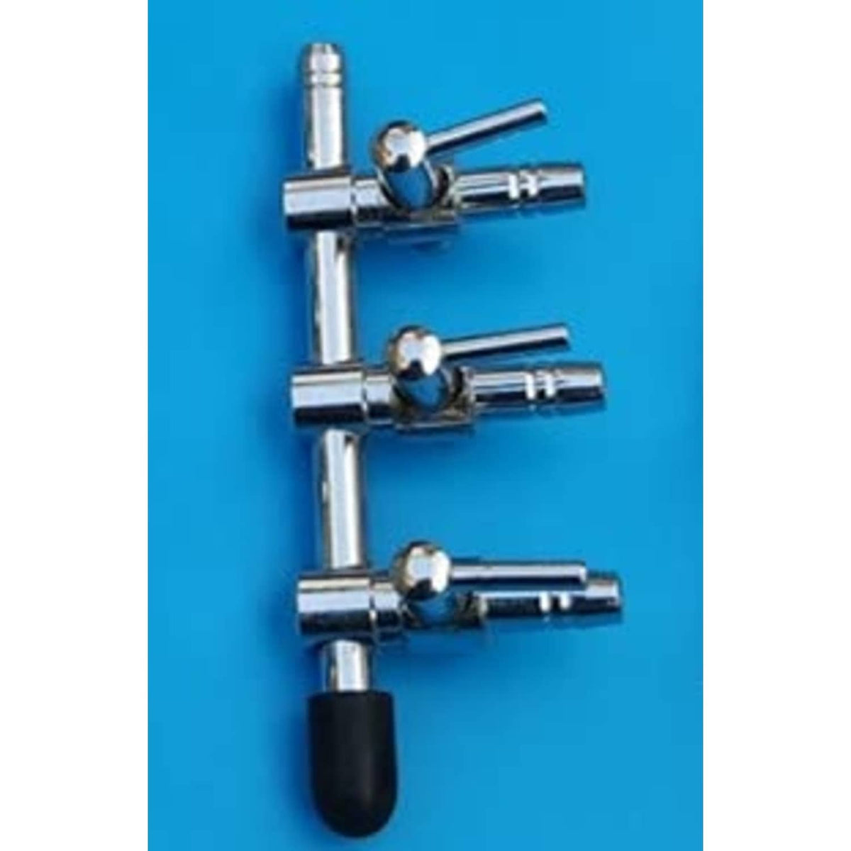 Close-up of three silver 3-way air line control valves with black rubber handles