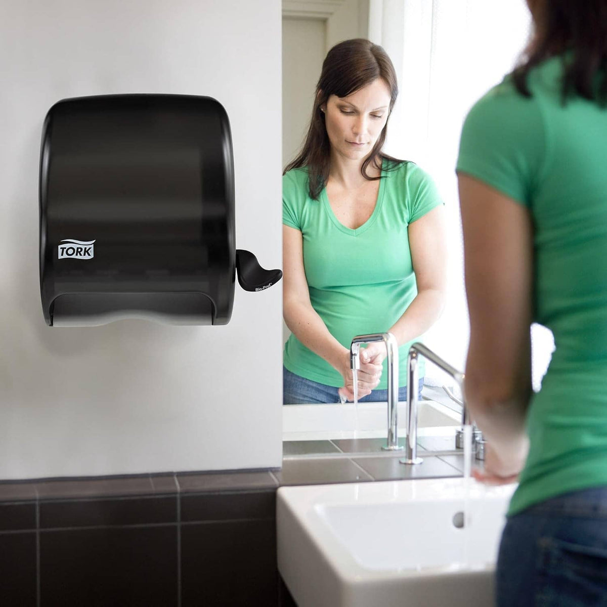 Black Tork countertop paper towel roll dispenser with front lever