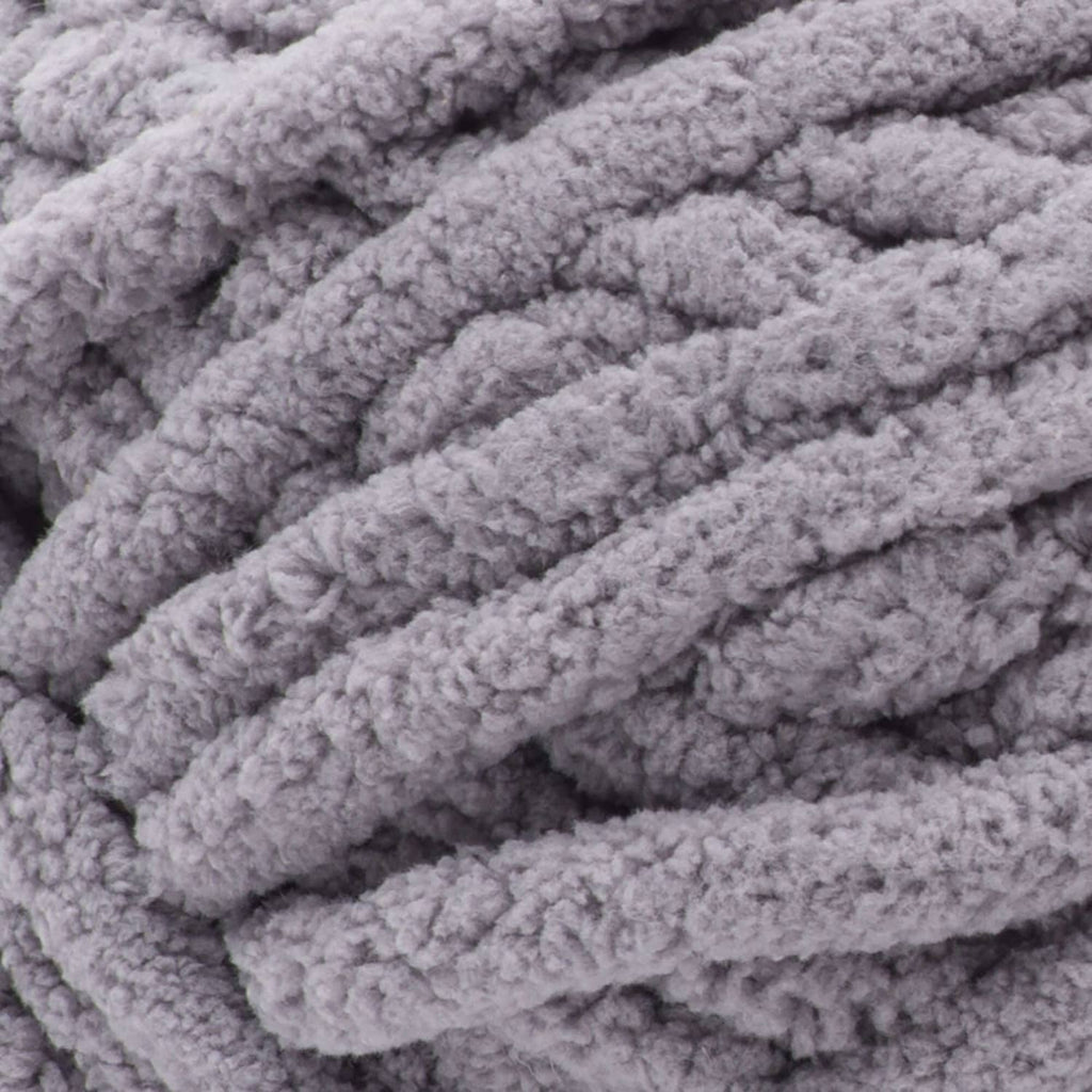 Close-up of gray chenille-style yarn with thick ribbed loop texture