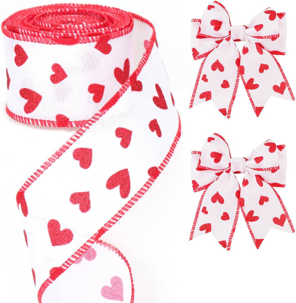 White wired ribbon with red hearts, coiled roll and loose ribbon end with stitched edge