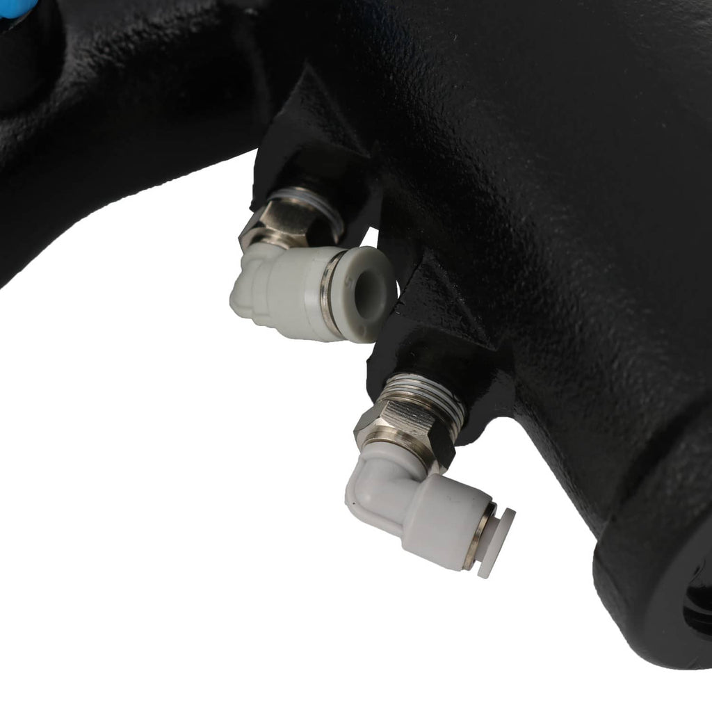 Close-up of pump body with metal threaded fittings and clear connector caps