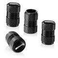 Set of black textured tire valve stem caps with AMG logo, shown from multiple angles