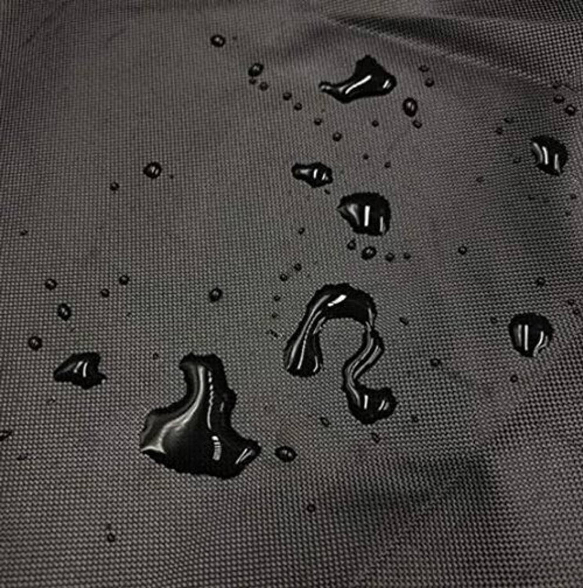Black waterproof log splitter cover fabric with water droplets close-up