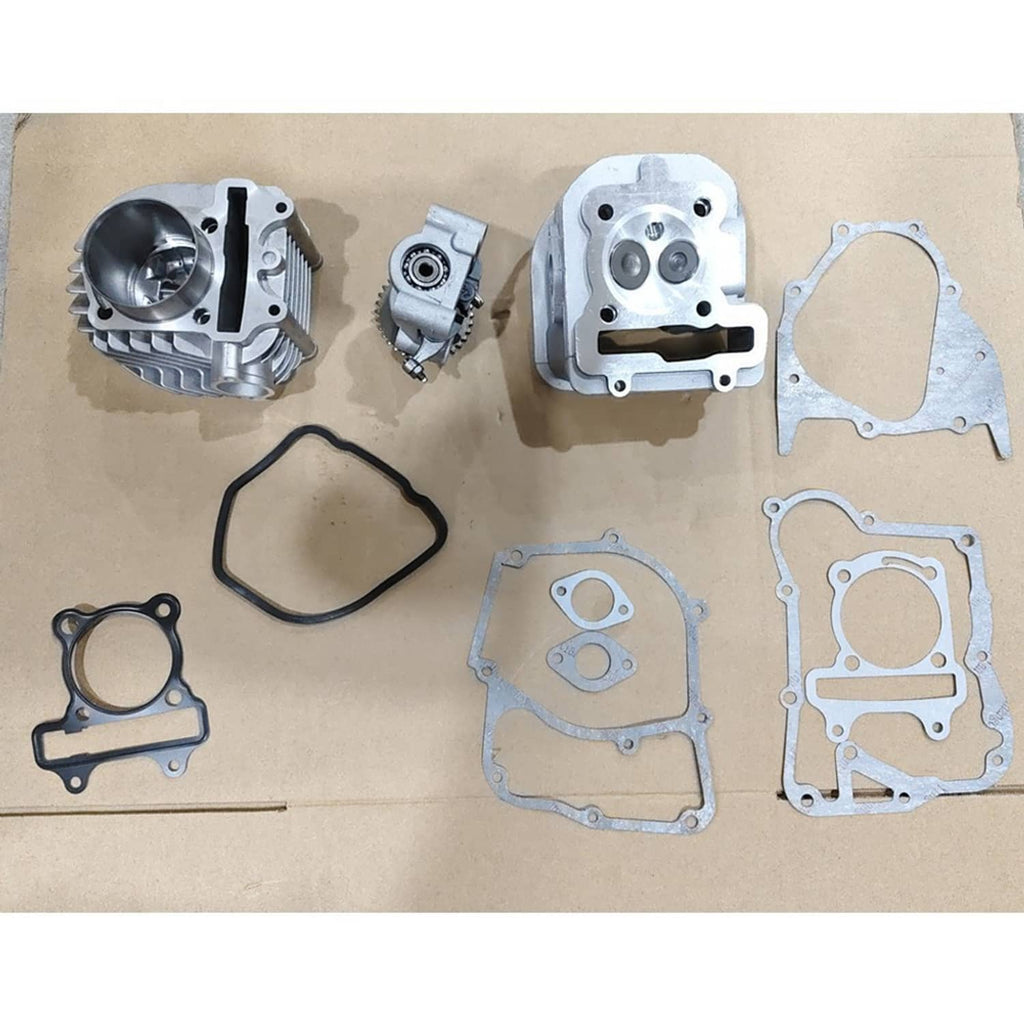 Big bore cylinder kit components laid out: cylinder, head, and multiple blue-tinted gaskets