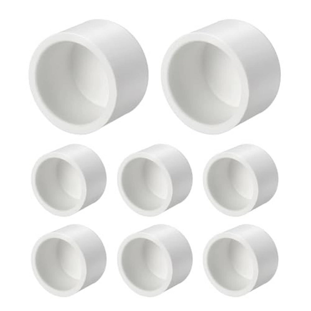 White PVC external end cap fittings with open socket ends, angled view, set of pieces