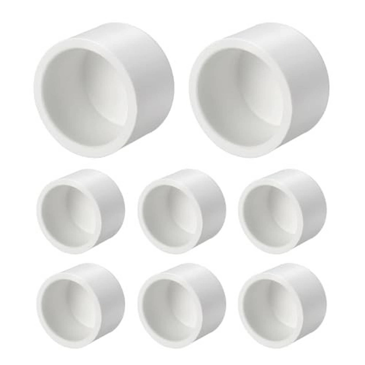 White PVC external end cap fittings with open socket ends, angled view, set of pieces