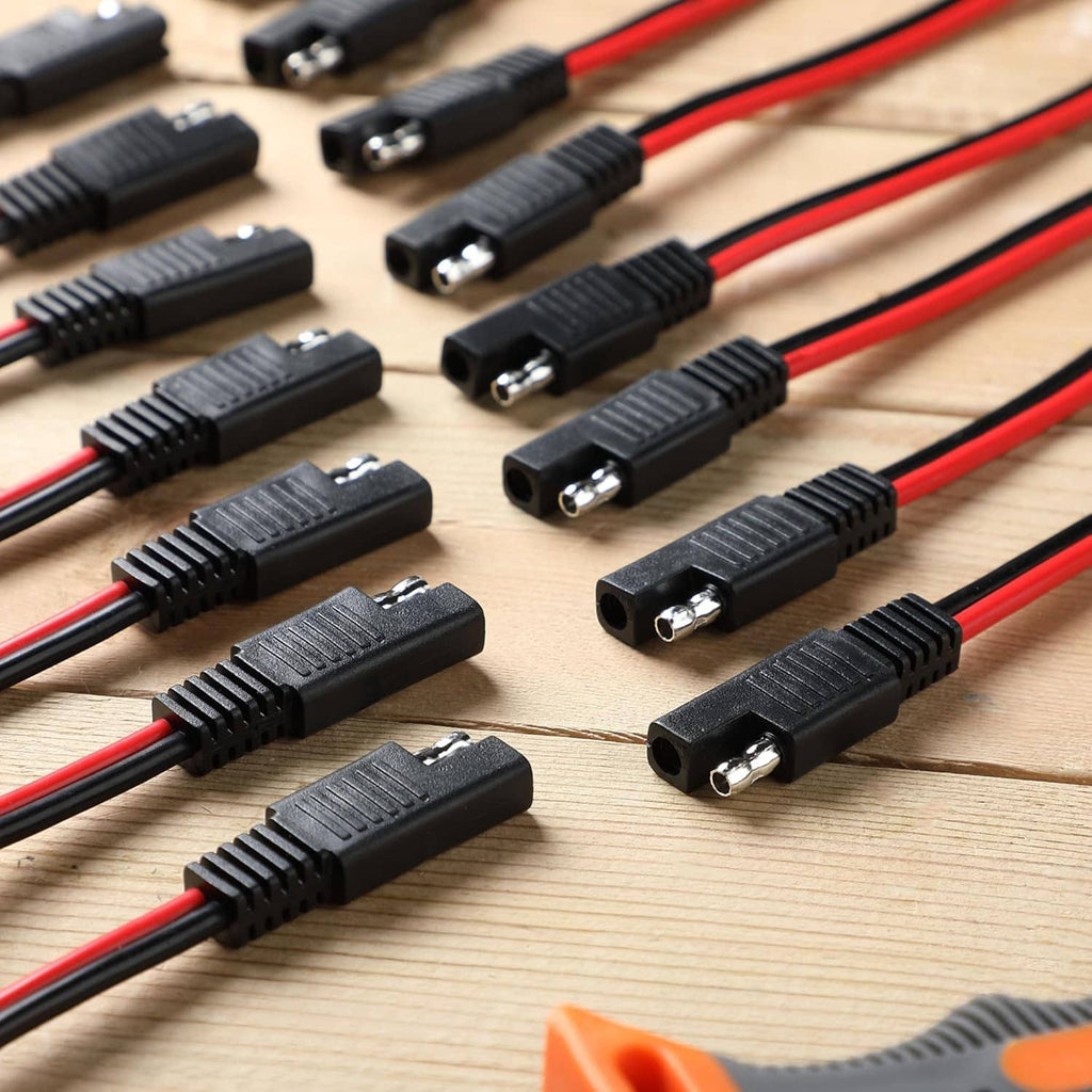 Close-up of SAE connector plugs with black housings and red/black wire leads