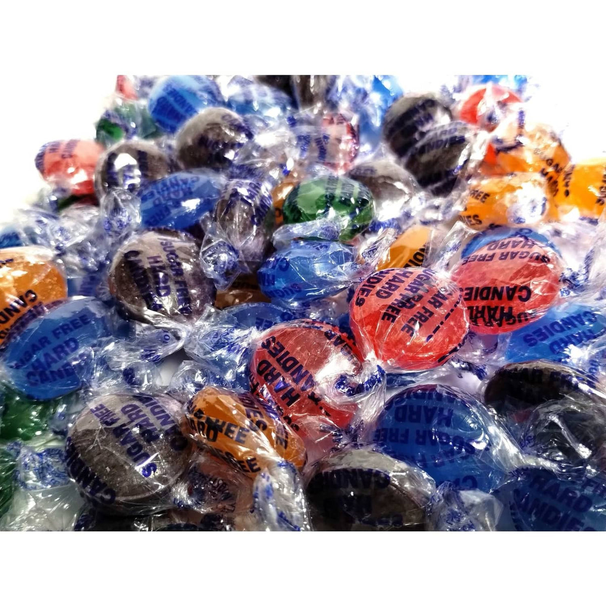 Close-up of sugar-free fruit hard candies in clear individual wrappers, mixed colors