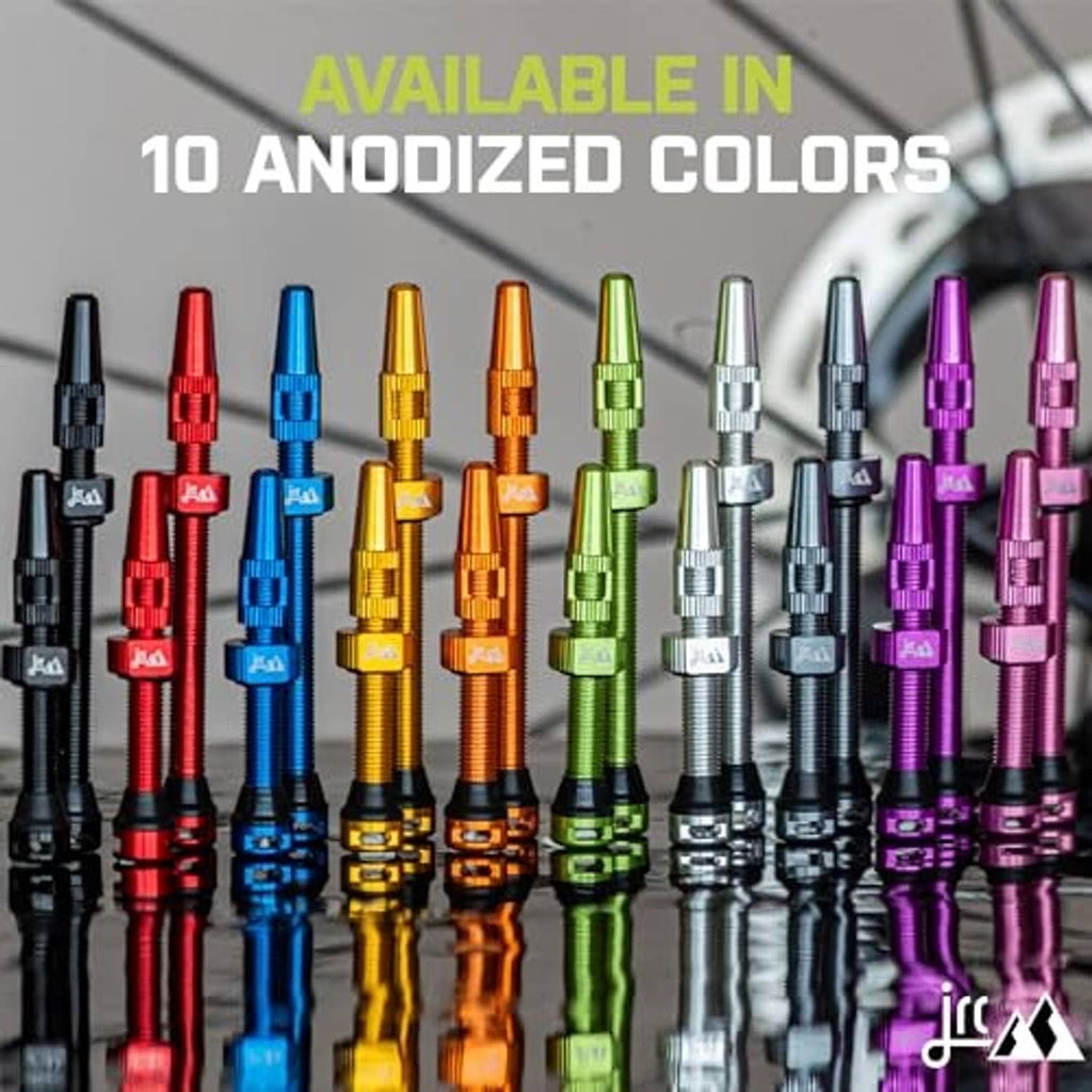 Assorted anodized Presta tubeless valve stems in many colors, lined up for selection.