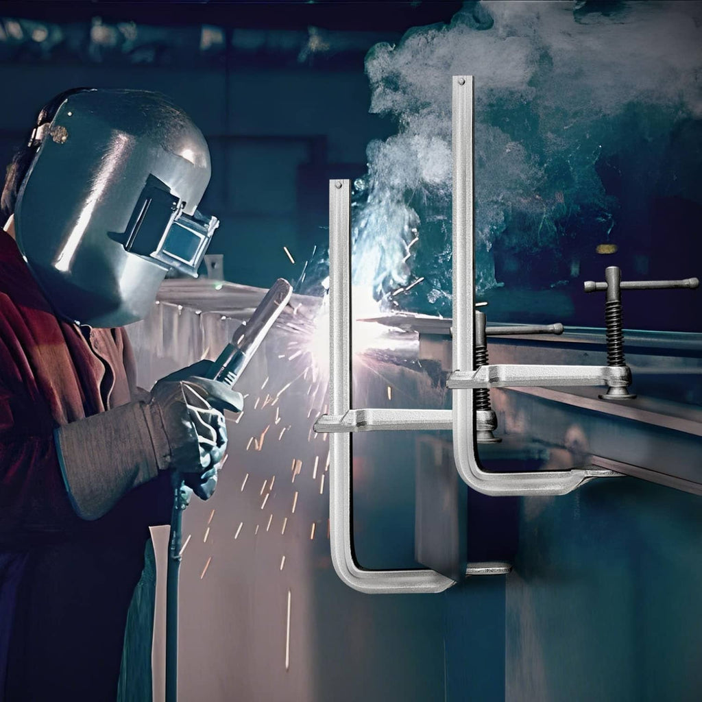 Silver U-bolt clamp securing metal workpiece during welding