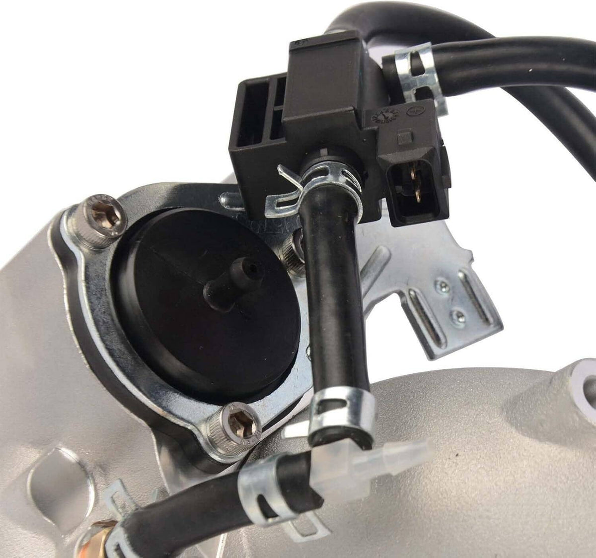 Turbocharger intake-side view with black electrical connector and circular inlet opening